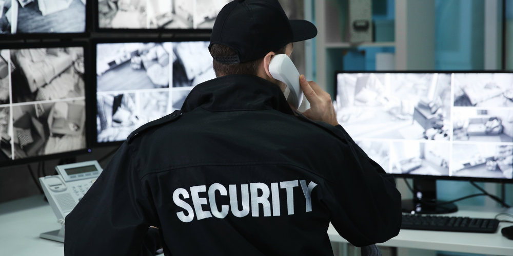 Professional security guard monitoring surveillance systems